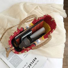 an open purse sitting on top of a table next to a book and pen holder