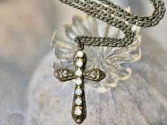 "This is a simple classic brass cross on a brass link chain. It will make a perfect cross with a touch of rhinestone detail. The perfect gift for that someone special. I T E M ∙ S P E C I F I C A T I O N S: - CHAIN LENGTH: 20\" in length brass link Chain  - PENDANT SIZE: Brass Charm is 1 1/4\" X 1 7/8\" C A R E ∙ T I P S: We don't want your special treasure to fade. To maintain the quality of your jewelry, please: - Do not wear it to the pool, spa, or the beach - Remove when sleeping, exercising White Cross Necklace With Adjustable Chain, Brass Cross Pendant Necklace As Gift, Vintage White Cross Jewelry, White Cross Necklace For First Communion, Cross Necklace Simple, Necklace Simple, Brass Charms, Pool Spa, White Rhinestone