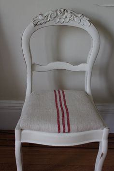 a white chair with a red stripe on the seat