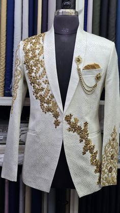 Elevate Your Style with This Exquisite Embroidered Blazer One Piece | Only Blazer Please Contact us for Complete 3 Piece suit. Customization Available 🎉🎉 Make a statement with this stunning embroidered blazer, crafted for the modern man who appreciates intricate details and timeless elegance. The pristine white canvas of this blazer is beautifully adorned with intricate gold embroidery, creating a captivating contrast that is both sophisticated and bold.  The delicate floral motifs, meticulous Tuxedo For Groom, Blazer Design, Embroidered Blazer, Dark Suit, Wedding Tuxedo, Gemstone Wedding, Tailored Suit, Blazer Style, Guest Attire