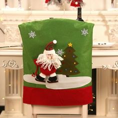 a christmas chair cover with a santa clause standing next to a tree and snowflakes