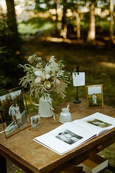 a wooden table topped with pictures and flowers