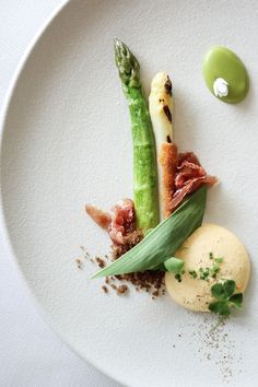 a white plate topped with asparagus and other food