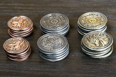 five different types of coins sitting on top of a wooden table