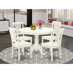 a white table with four chairs around it