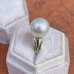 Two-tone 14KT white gold + yellow gold band ring with genuine, cultured Paspaley South Sea Pearl. Choose your finger size Contact us for additional sizes 12mm Paspaley Pearl; "Fine" quality; "Circle" shape Paspaley Certificate of Authenticity included Weight: 6.31g Made to order: please allow 7-10 business days prior to shipping Pearl will vary slightly from photos Classic White Dome Ring For Wedding, White Round Dome Ring For Anniversary, White Dome Ring Fine Jewelry, White Round Pearl Ring Stamped 14k, White Pearl Ring In 14k Gold, Hypoallergenic Round Pearl Ring For Anniversary, Hypoallergenic Pearl Ring For Anniversary, Classic White Hypoallergenic Rings, South Sea Pearl Ring