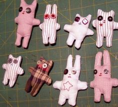 several small stuffed animals sitting on top of a cutting board