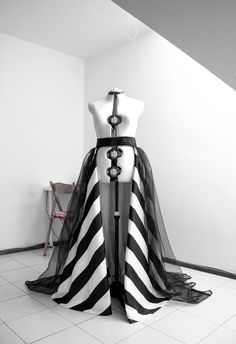 Absolutely stunning black and white taffeta overskirt with tulle layer on top and lace trim. Stripes are all handmade so if you want this gown in other color combinations or all skirt to be one color (no stripes) i will make it special for you! You can wear it over your dress, romper, jumpsuit, bodysuit, pants as you love it most. What you have to send when you place an order: 1 Waist round measurement 2 Straight line from waist to floor ( this is not skirt length ) 3 Color prefer 4 Phone number Black Organza Gown With Sheer Details, Organza Dress With Voluminous Long Skirt, Black Tulle Dress With Voluminous Skirt, Fitted Tulle Skirt With Long Train, Black Skirt With Attached Cancan For Wedding, Elegant Party Skirt With Detachable Train, Black Full Skirt Dress With Attached Cancan, Fitted Skirt With Detachable Long Train, Black Wedding Dress With Voluminous Skirt