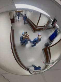 two doctors in scrubs are reflected in the mirror