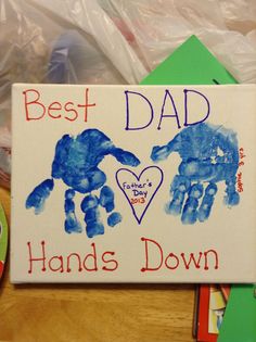 a sign that says best dad and hand's down with two hands painted on it