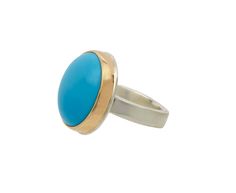 Striking in its eye catching color of saturated sky blue, this Jamie Joseph ring is a bold, statement making piece of jewelry. The smooth, large round stone is framed in a bezel of 14K gold and centered on Jamie's signature sterling silver groovy band. Turquoise is believed to facilitate loving, compassionate behavior and helps the wearer to recover from emotional disputes.sleeping beauty turquoise : 18mm diametersterling silver groovy band width : 4.5mmsize available : 7.5resizing fee : $110-$1 Elegant Blue Jewelry With Smooth Bezel, Classic Blue Domed Jewelry, Blue Domed Gemstone Ring, Blue Domed Jewelry With Polished Finish, Modern Blue Turquoise Gemstone Ring, Modern Blue Rings With Large Stone, Modern Turquoise Round Ring, Turquoise Ring With Bezel Setting, Blue Cabochon Dome Ring