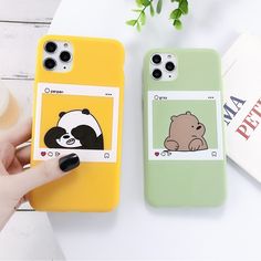 two cell phones with panda and bear stickers on them, one is green and the other is yellow