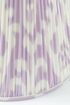 a purple and white lamp shade on a white background