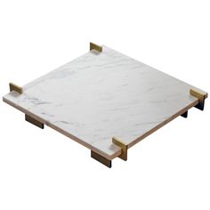 a white marble and brass square tray with two handles on each side, set against a white background