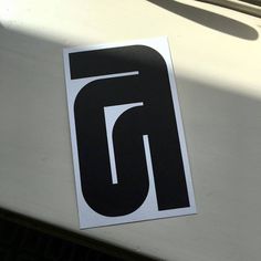 a sticker on the hood of a car that says,'6'in black and white