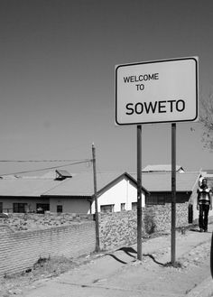 a welcome to soweto sign in black and white