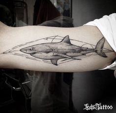 a man with a shark tattoo on his arm