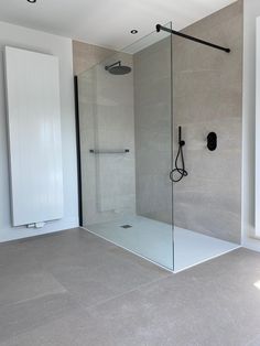 a bathroom with a walk in shower next to a window