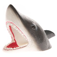 a toy shark with its mouth open on a white background