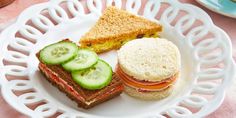 a plate with sandwiches and cucumbers on it