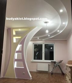 an empty room with wooden flooring and white painted walls, has a spiral staircase leading up to the window