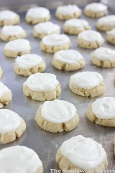 the cookies have white icing on them and are ready to be baked in the oven