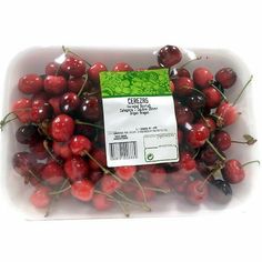 a plastic container filled with lots of cherries