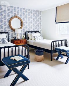 a room with two twin beds and a small table in front of the bed is instagram