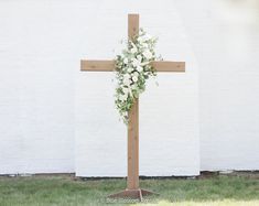 This beautiful, hand-made, cedar cross is the perfect addition for any outdoor or indoor wedding. We added beautiful white playa blanca roses, white ranunculus, ivory spray roses, ivory veronica, and sage eucalyptus, with touches of clematis draping down the sides.  The flowers shown come with the arch, unless requeste Rustic Cross Wedding Alter, Wedding Arch With White Roses, White Flowers On Cross Wedding, Floral On Cross Wedding, Cross With White Flowers, Flowers On Wooden Cross Wedding, Wedding Ceremony Alter Flowers, Cross Florals For Wedding, Cross Floral Wedding