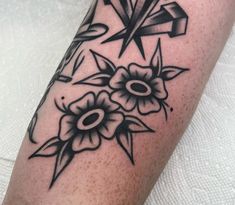 a black and white tattoo design on the arm