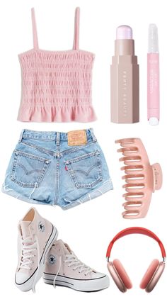 a pink top, jean shorts and headphones are arranged in the shape of a heart