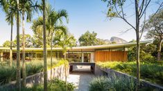 the house is surrounded by lush vegetation and trees