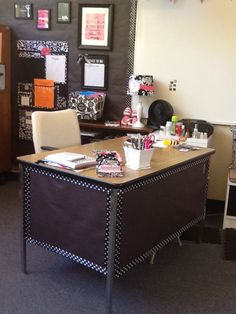 an office with two desks, chairs and pictures on the wall above them is decorated in black and white