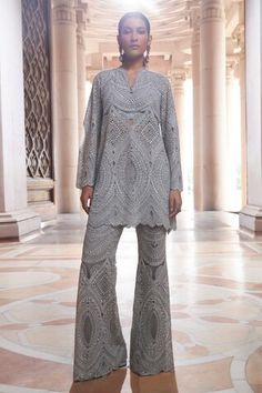 Grey top with sequin, cutdana, bead, zari thread embellishment in geometric pattern. Paired with flared pant. - Aza Fashions Fitted Cutwork Sets For Festive Occasions, Festive Fitted Sets With Cutwork, Fitted Cutwork Sets For Festivals, Embellished Fitted Sets For Diwali, Festive Designer Palazzo Set With Cutwork, Festive Designer Cutwork Palazzo Set, Festive Cutwork Palazzo Set, Traditional Festive Cutwork Tops, Fitted Embellished Peplum Palazzo Set