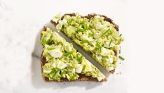 an open faced sandwich with avocado on it