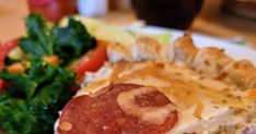 a close up of a plate of food with broccoli and other foods in the background