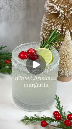 a white christmas margarita with cranberries and lime