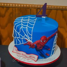 a birthday cake with a spiderman design on it