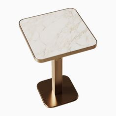 a white and gold table with a square marble top on a metal stand, against a white background