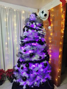 a purple christmas tree with black and white decorations