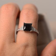 Elegant Square-cut Sapphire Ring In Sterling Silver, Classic Black Sapphire Ring In Sterling Silver, Classic Black Spinel Sapphire Ring For Anniversary, Elegant Black Spinel Sapphire Ring For Anniversary, Black Sapphire Ring In Sterling Silver For Formal Occasions, Classic Sapphire Ring With Black Spinel For Promise, Elegant Black Spinel Sapphire Promise Ring, Black Rings With Rectangular Stone For Anniversary, Black Rectangular Stone Ring For Anniversary