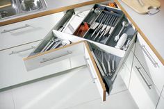 an open drawer with utensils in it