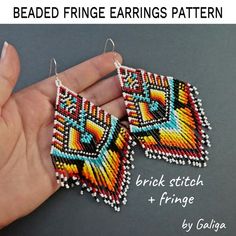 the beaded fringe earrings pattern is being held in someone's hand with their fingers