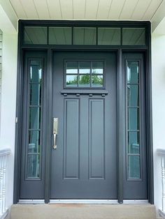 a gray front door with two sidelights