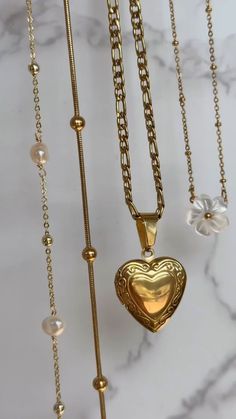 gold heart locket necklace, gold choker, gold neck stack, gold jewelry, gold jewelry inspo, summer jewelry inspo Gold-tone Heart Pendant Necklace With Adjustable Chain, Gold-tone Heart Necklace With Adjustable Chain, Gold Heart-shaped Locket Necklace With Adjustable Chain, Heart-shaped Gold Locket Necklace With Adjustable Chain, Heart-shaped Gold-tone Charm Necklace With Adjustable Chain, Gold-tone Locket Chain Necklace As Gift, Gold-tone Chain Necklace With Locket For Gift, Gold Heart Necklace With Adjustable Chain And Round Pendant, Adjustable Gold Locket Charm Necklaces