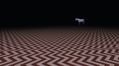 a white horse standing in the middle of a room with brown and white chevron flooring