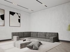 a large gray couch sitting on top of a white rug