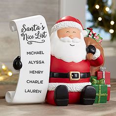 a santa clause figurine next to a sign that says santa's nice list