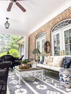 an outdoor living room with furniture and decor