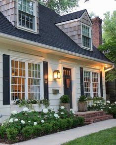 a white house with black shutters and windows